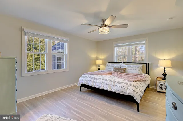 a bedroom with a bed lamp and a window
