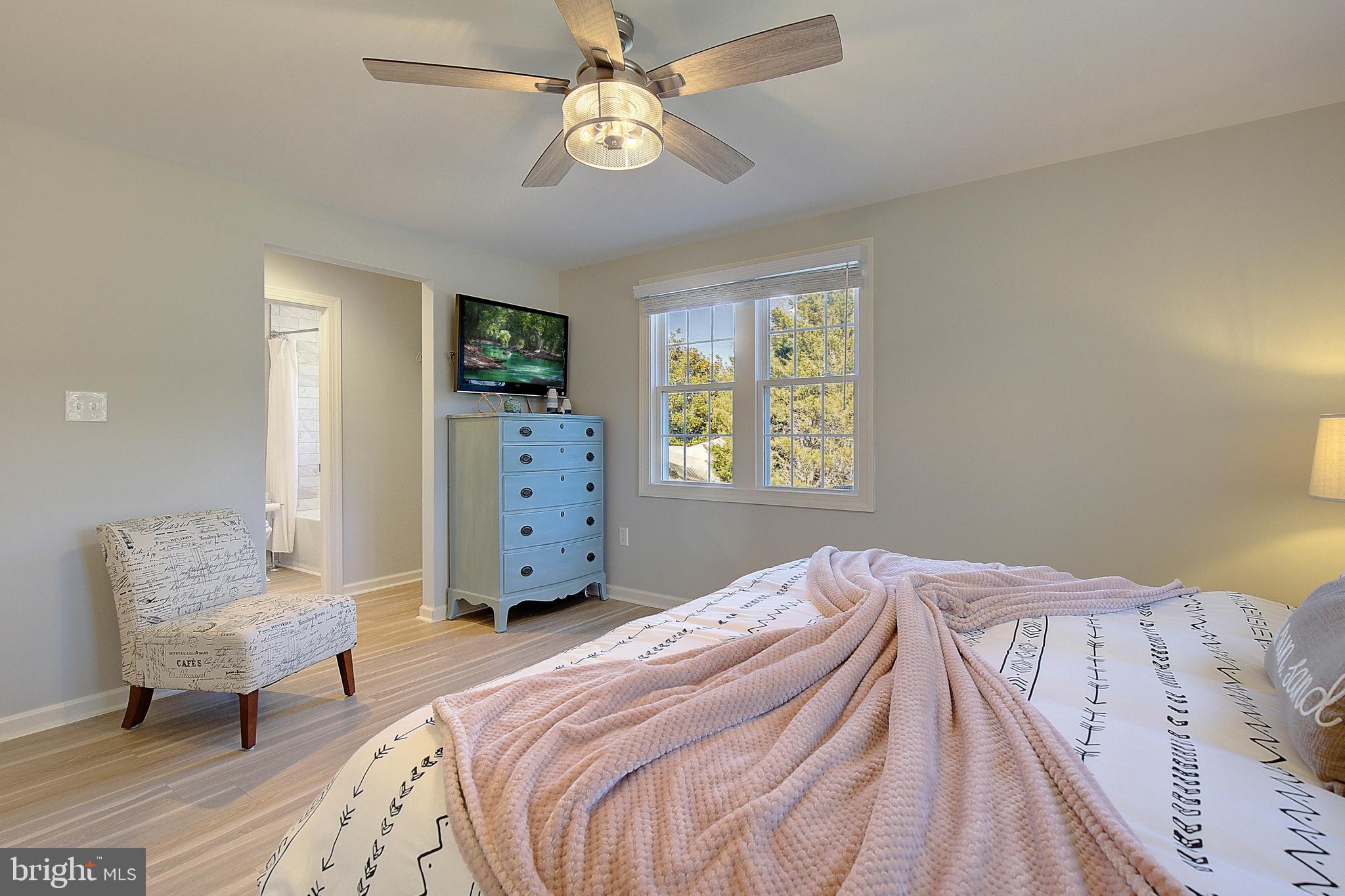 20938 Olen Mattingly Road Avenue, MD 20609 - Photo 17 of 47 a bedroom with a bed and a chandelier