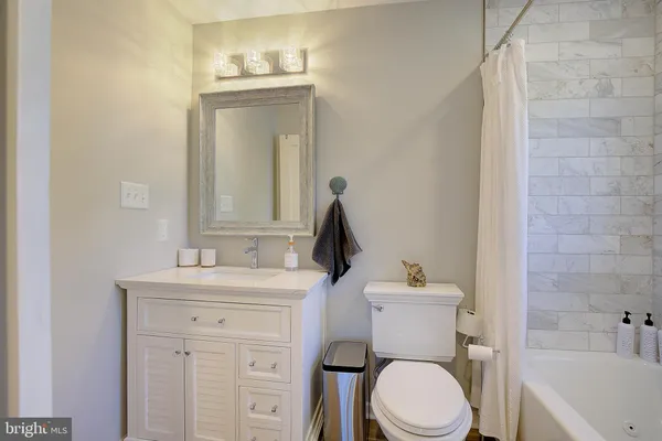 a bathroom with a sink a toilet and mirror