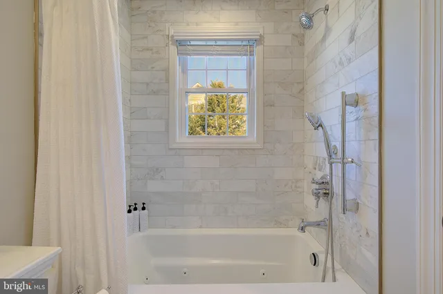 a bathroom with a bathtub and shower