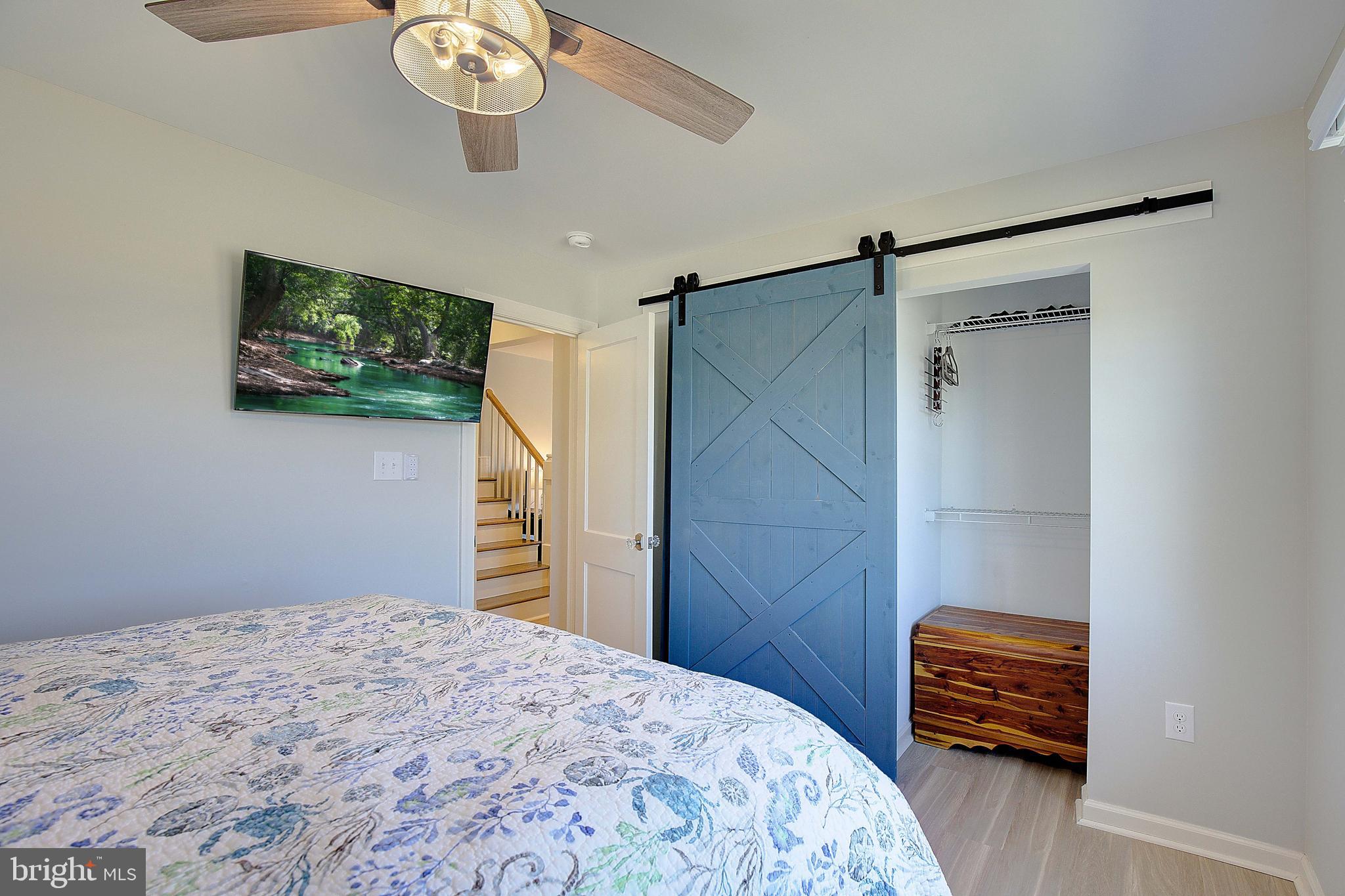 20938 Olen Mattingly Road Avenue, MD 20609 - Photo 23 of 47 a bedroom with a bed and a chandelier