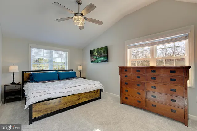 a bedroom with a bed dresser and a window