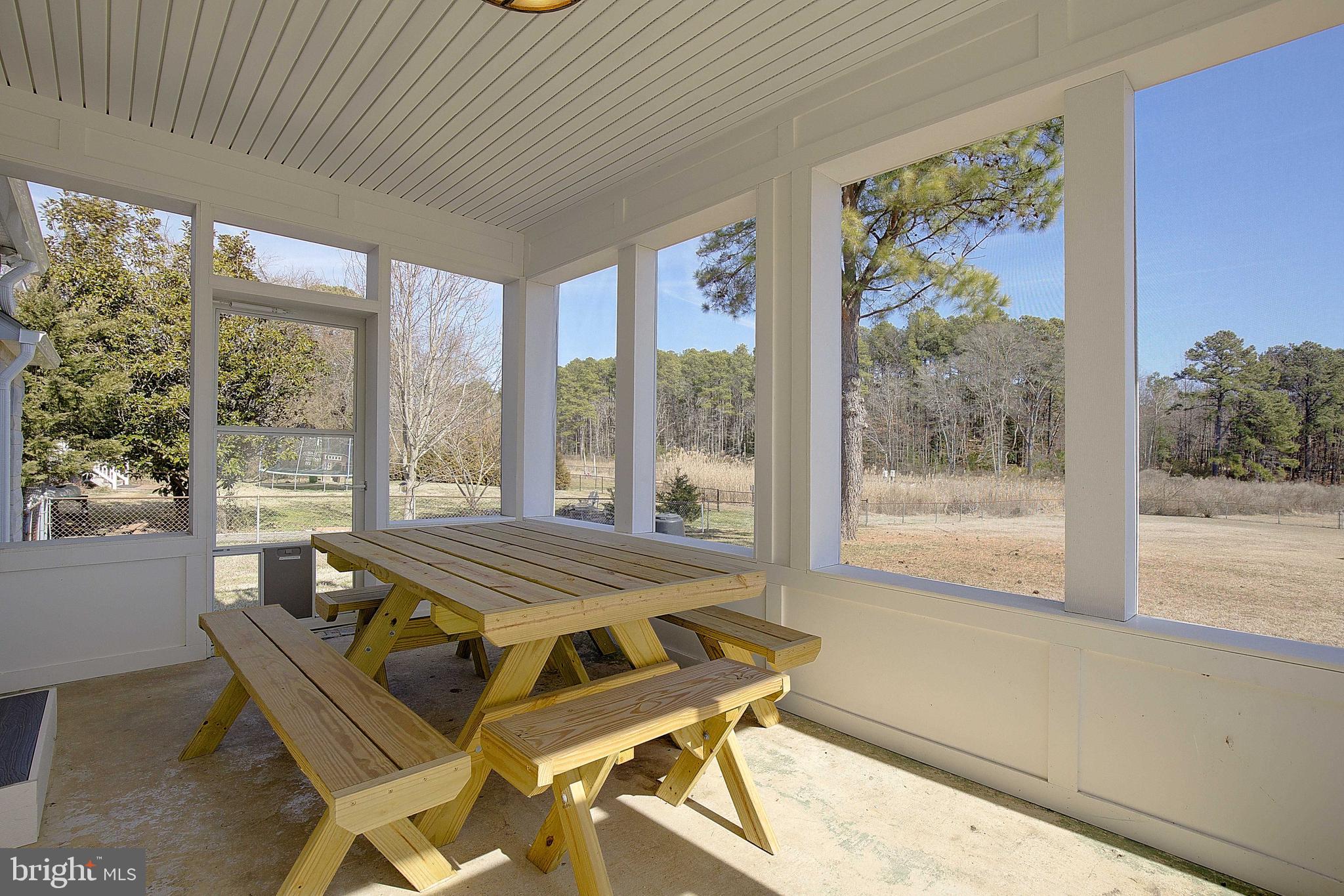 20938 Olen Mattingly Road Avenue, MD 20609 - Photo 40 of 47 a view of a dining room with furniture large windows and wooden floor