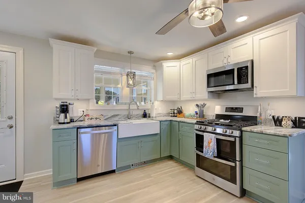 a kitchen with stainless steel appliances granite countertop a stove and a sink