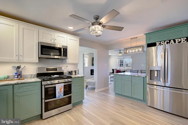 a kitchen with a refrigerator stove and microwave