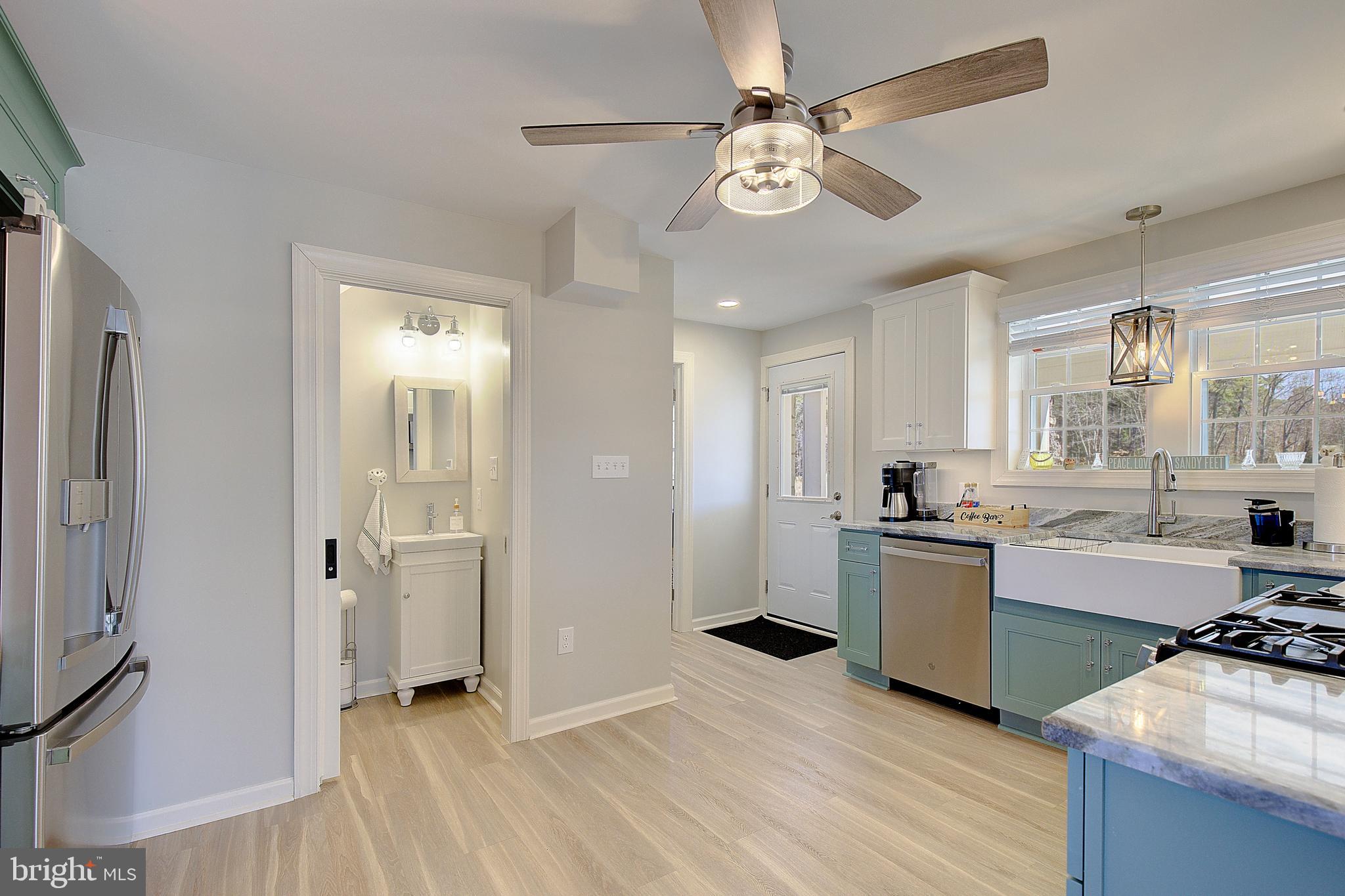 20938 Olen Mattingly Road Avenue, MD 20609 - Photo 10 of 47 a view of a kitchen with a sink dishwasher stove and refrigerator with wooden floor