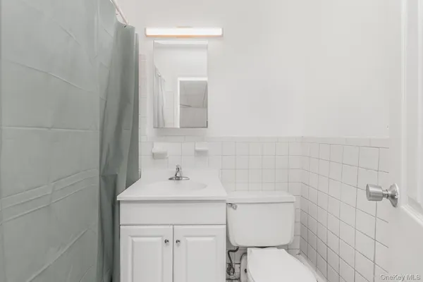 a bathroom with a sink toilet and mirror