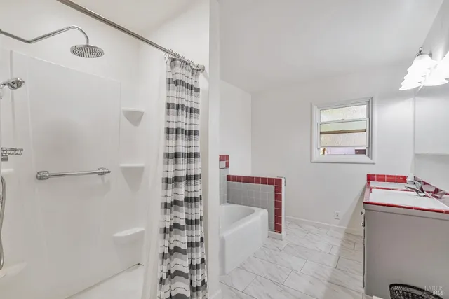 a bathroom with a bathtub and shower