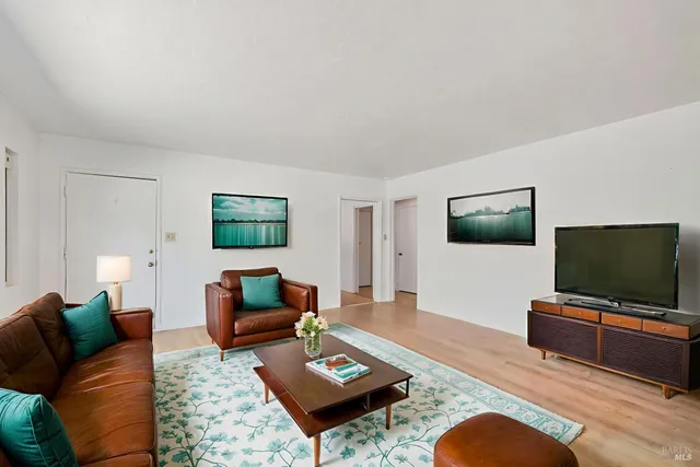 a living room with furniture and a flat screen tv