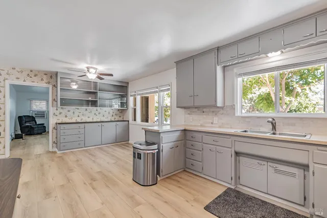 a kitchen with a sink cabinets and window