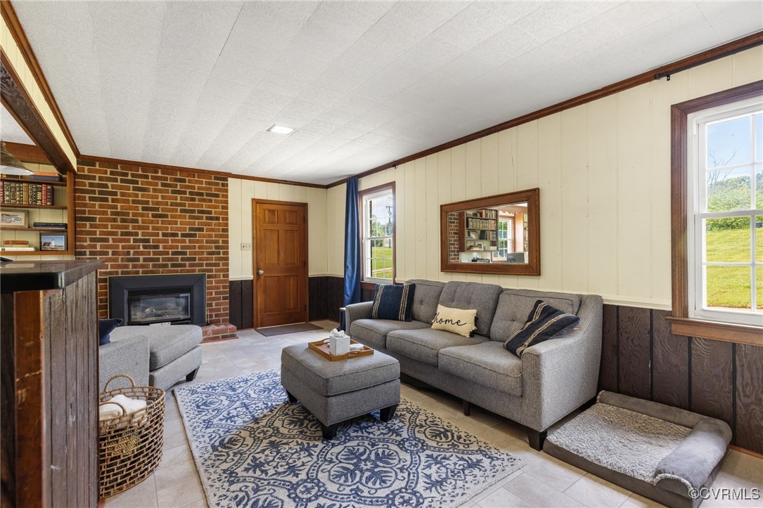 2137 Dogtown Road Goochland, VA 23063 - Photo 18 of 40 Living room with crown molding, wood walls, tile p