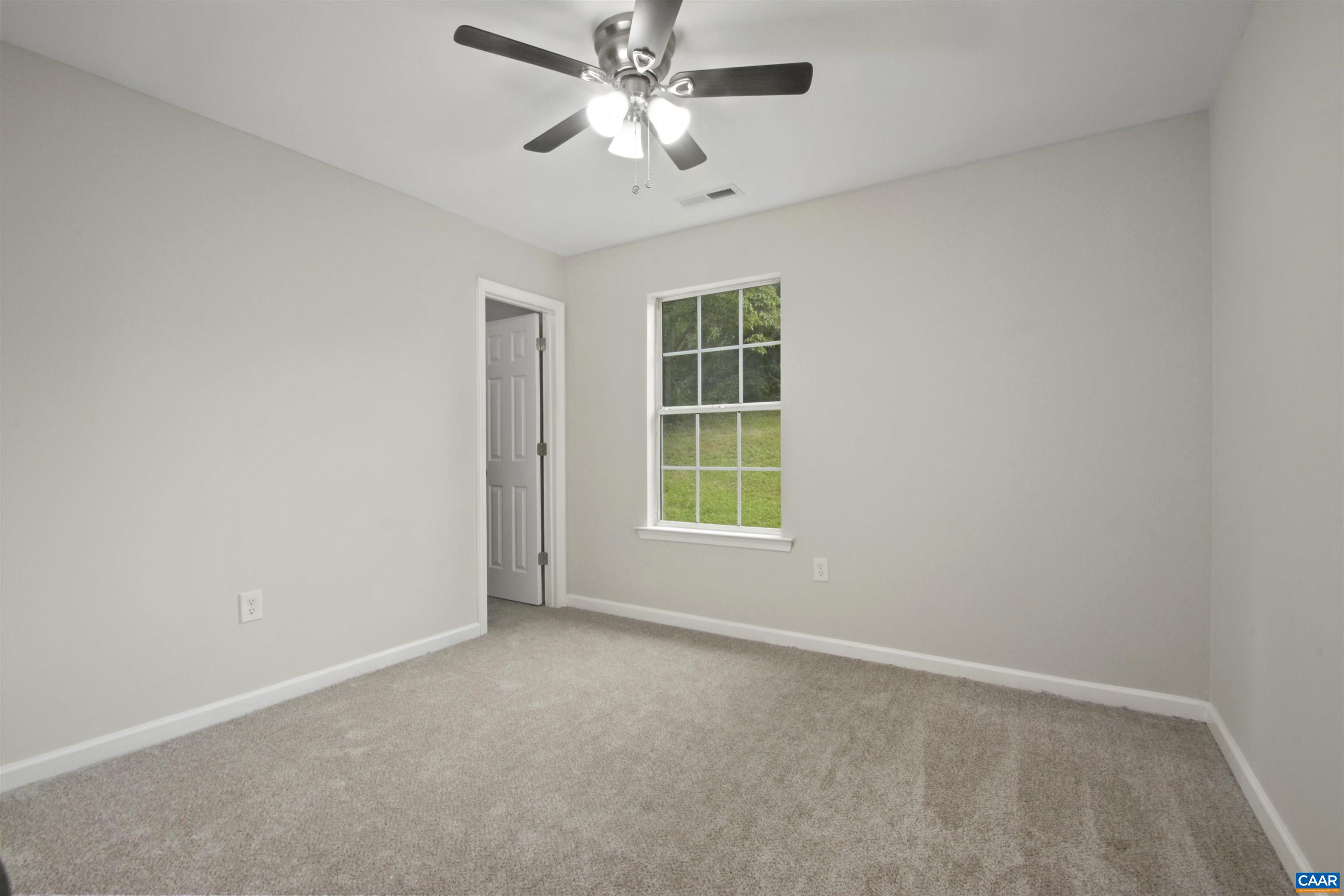 263 Morning Glory Road Ruckersville, VA 22968 - Photo 14 of 24 an empty room with windows and fan