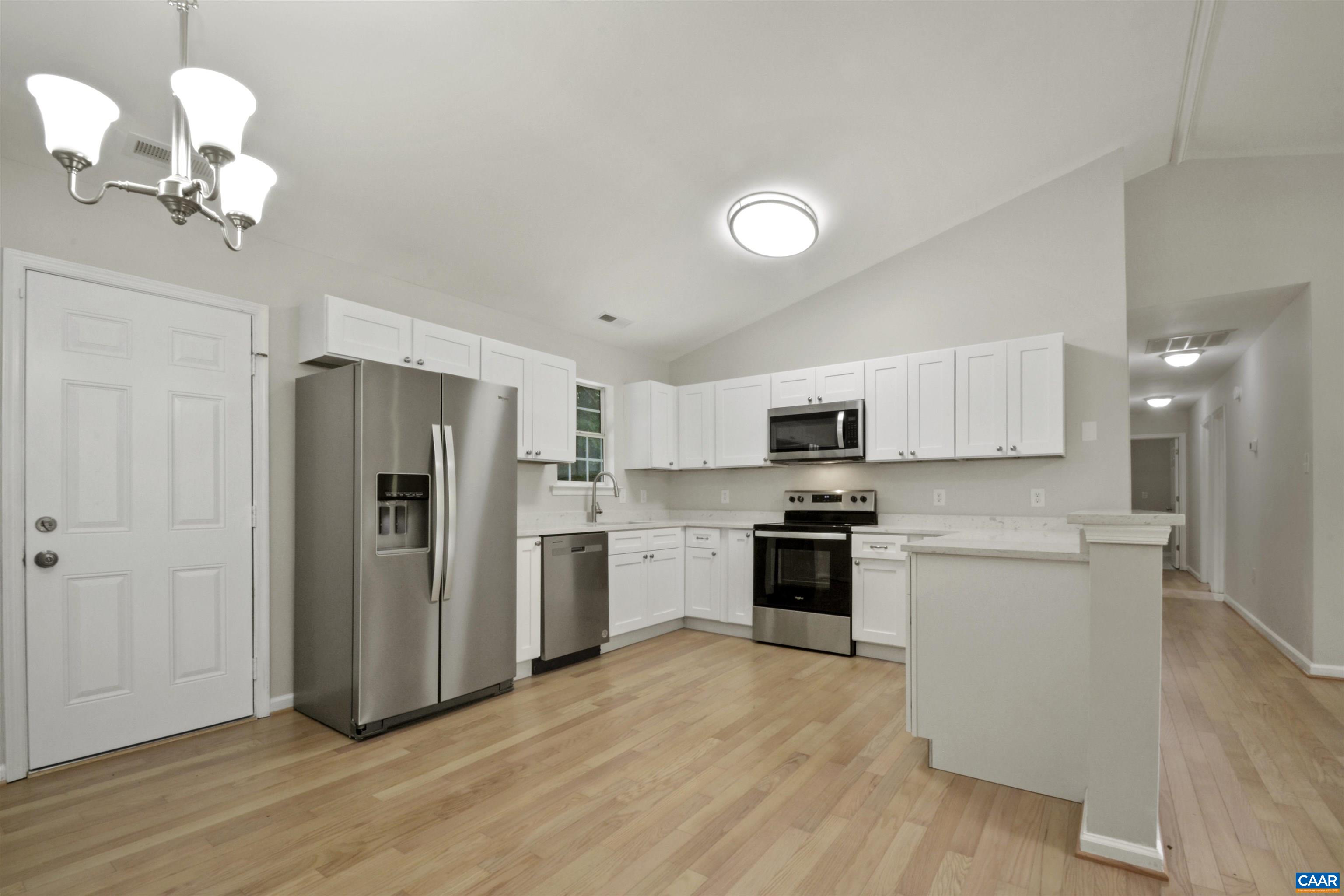 263 Morning Glory Road Ruckersville, VA 22968 - Photo 7 of 24 a kitchen with stainless steel appliances granite countertop a refrigerator a stove oven a sink dishwasher and a refrigerator with wooden floor