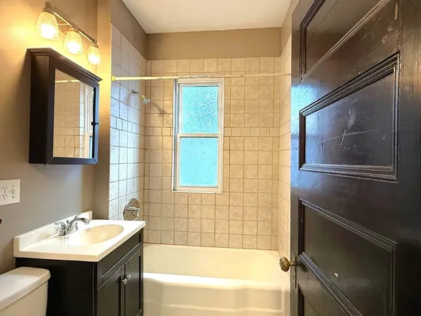 a bathroom with a sink mirror toilet and bathtub