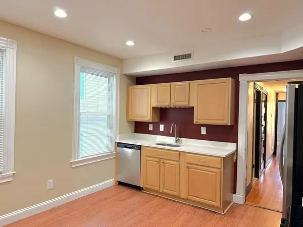 a kitchen with a sink stove and cabinets
