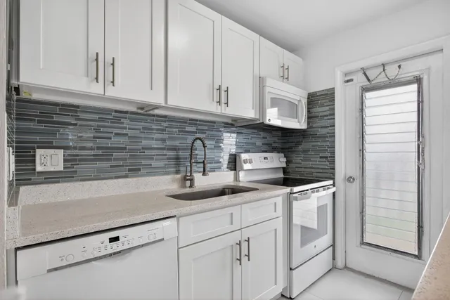 a kitchen with stainless steel appliances a sink and cabinets