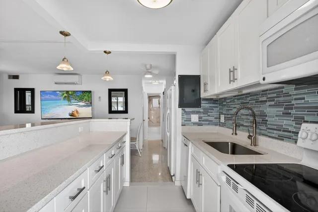 wooden floor with a sink and a large mirror in a room