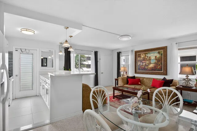 a view of a dining room with furniture and chandelier