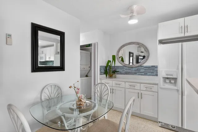 a dining room with furniture and a painting