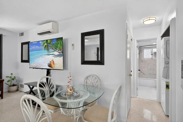 a bathroom with a granite countertop sink mirror toilet and bathtub