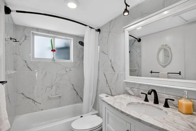 a bathroom with a sink a toilet and a bathtub