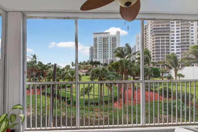 a car parked in front of a building with a parked car