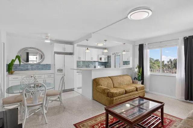 a kitchen with stainless steel appliances granite countertop a sink a refrigerator and a granite counter tops