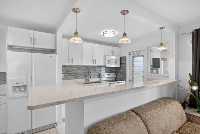 a kitchen with stainless steel appliances granite countertop white cabinets sink and dishwasher