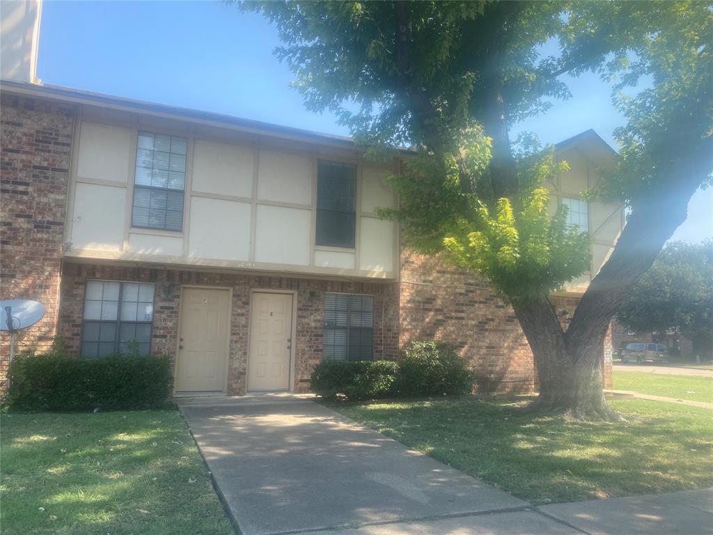 2809 Wimbledon Court, Unit C Garland, TX 75041 - Photo 2 of 23 a front view of a house with a yard and garage
