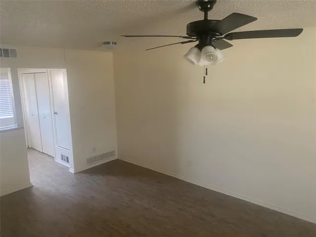 a view of empty room with a fireplace