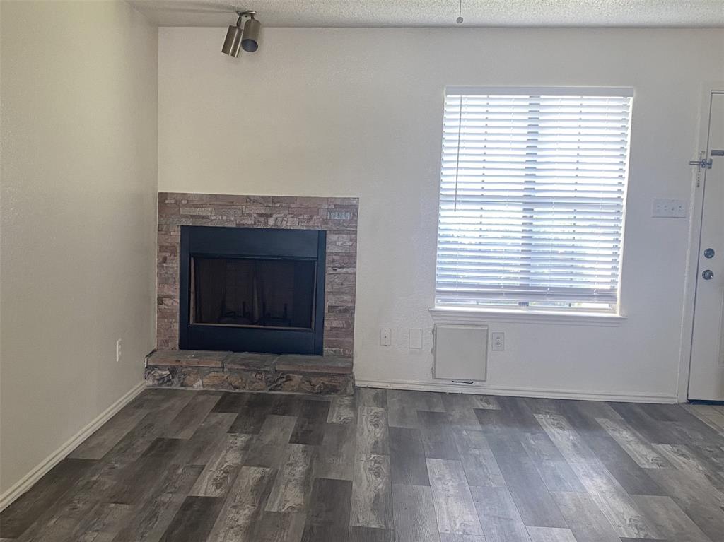 2809 Wimbledon Court, Unit C Garland, TX 75041 - Photo 9 of 23 a view of empty room with a fireplace