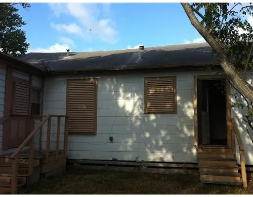 a side view of a house with a yard