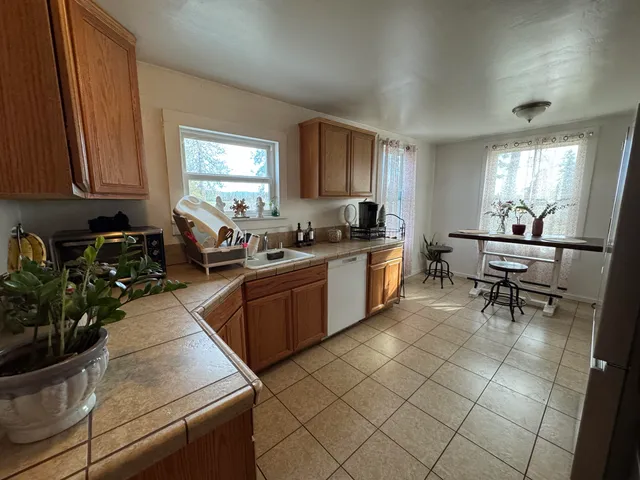 a kitchen with stainless steel appliances granite countertop sink stove and cabinets