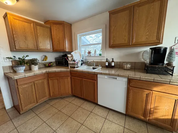 a kitchen with sink cabinets and microwave