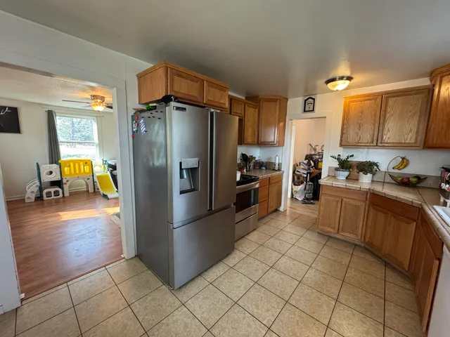 a kitchen with stainless steel appliances granite countertop a refrigerator and a stove
