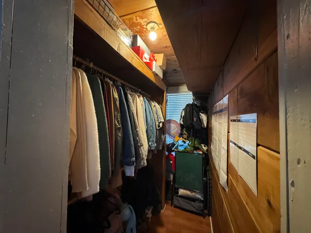 a living room with furniture a flat screen tv and gym equipment