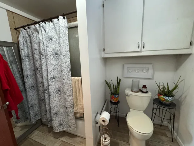 a view of a house with a yard and large trees