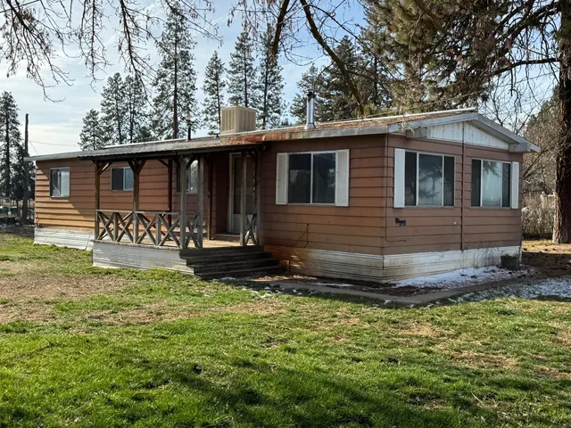 a kitchen with granite countertop a refrigerator and a sink