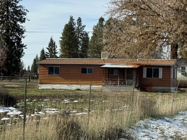 a kitchen with granite countertop a refrigerator a stove a sink and dishwasher