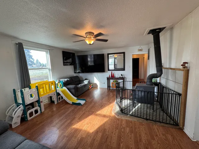 a view of a livingroom with furniture and a flat screen tv
