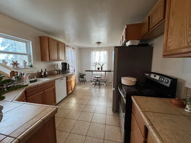 a kitchen with a sink a stove and refrigerator