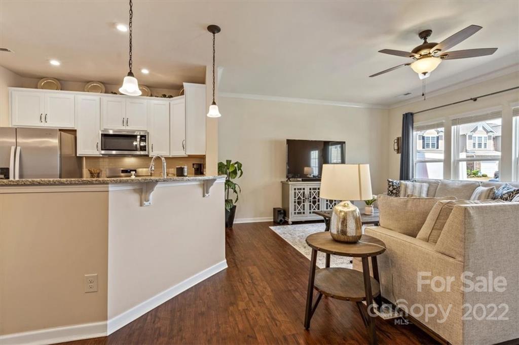 530 Hunters Dance Road Fort Mill, SC 29708 - Photo 12 of 35 a living room with furniture a dining table and a chandelier