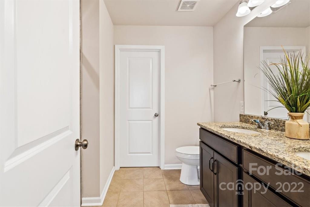 530 Hunters Dance Road Fort Mill, SC 29708 - Photo 25 of 35 a bathroom with a granite countertop sink toilet and shower
