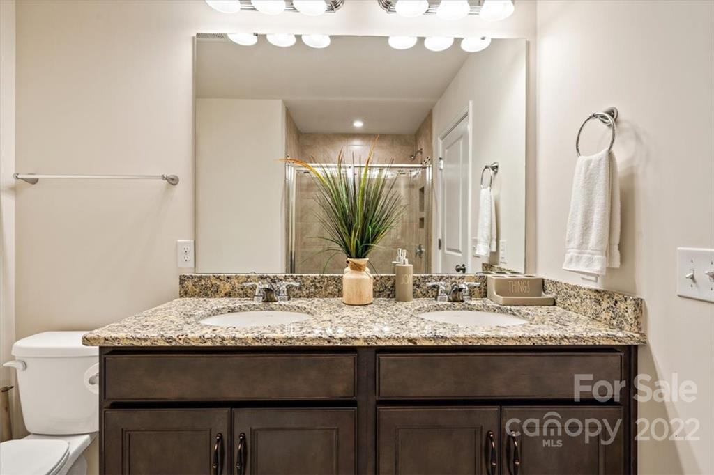 530 Hunters Dance Road Fort Mill, SC 29708 - Photo 26 of 35 a bathroom with a granite countertop sink a toilet and a mirror