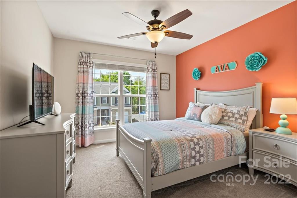 530 Hunters Dance Road Fort Mill, SC 29708 - Photo 30 of 35 a bedroom with a bed table flat screen tv and a large window