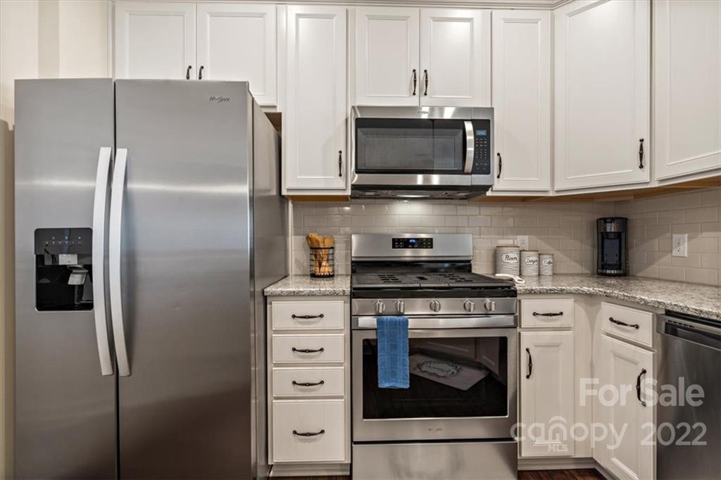 530 Hunters Dance Road Fort Mill, SC 29708 - Photo 10 of 35 a kitchen with stainless steel appliances white cabinets and a stove top oven