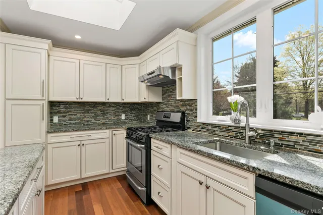 a kitchen that has a sink and a stove