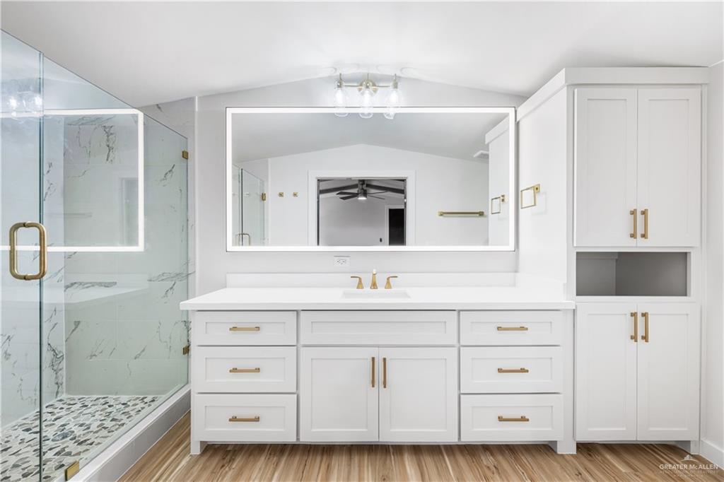 5501 Mile 8 1/2 Road Edinburg, TX 78541 - Photo 12 of 36 Full bath with vanity, a marble finish shower, light wood-type flooring, and vaulted ceiling