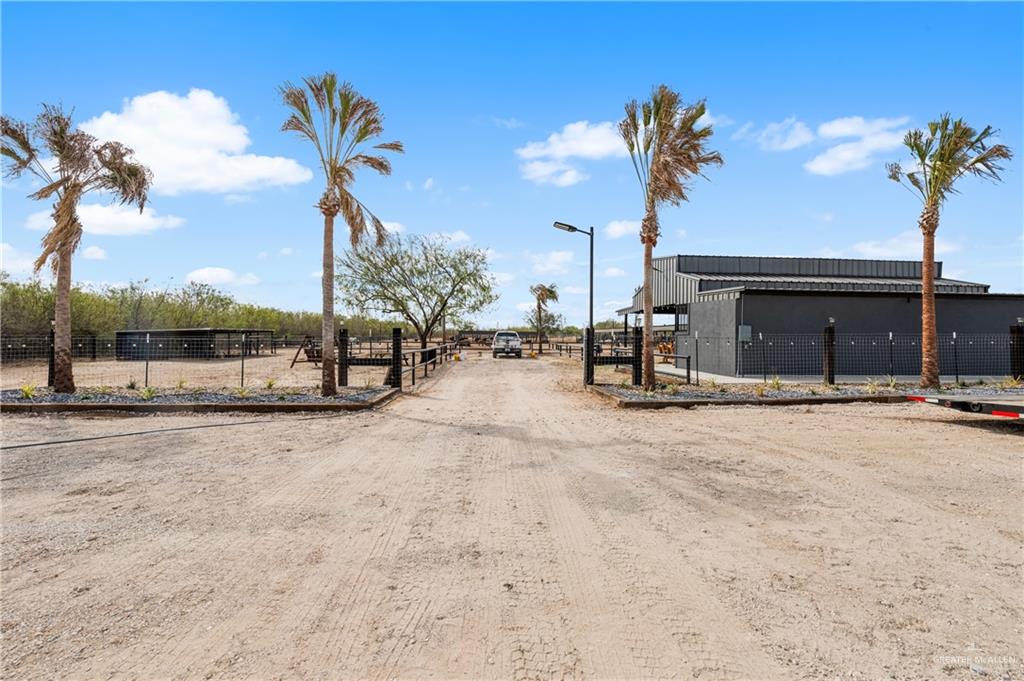 5501 Mile 8 1/2 Road Edinburg, TX 78541 - Photo 26 of 36 View of dirt / gravel driveway with a gated entry and a view of rural / pastoral area