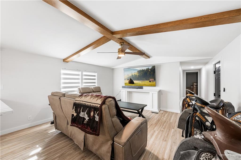 5501 Mile 8 1/2 Road Edinburg, TX 78541 - Photo 6 of 36 Living area with beamed ceiling, ceiling fan, and light wood-type flooring